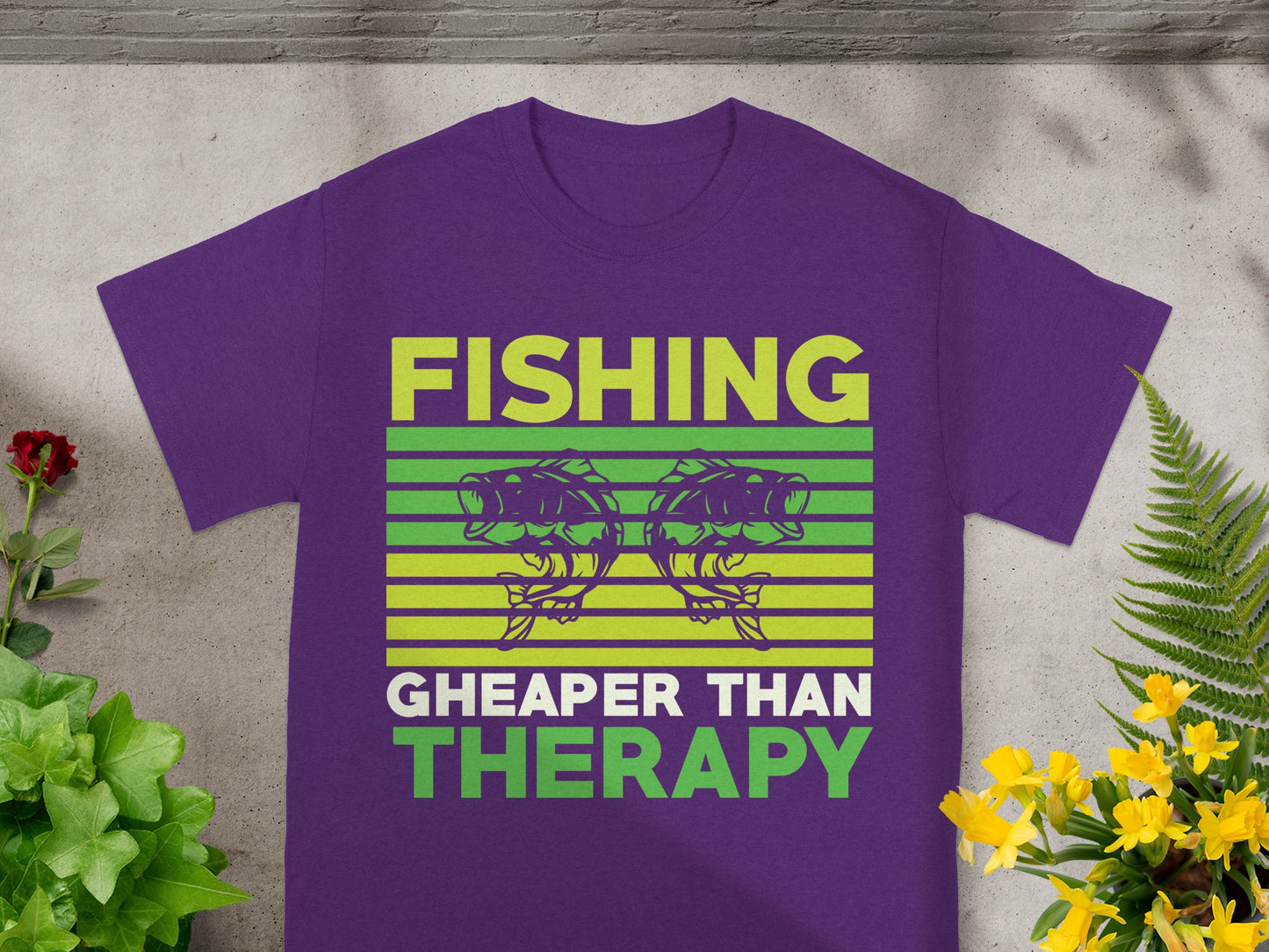Purple t-shirt with the text "FISHING CHEAPER THAN THERAPY" and two fish.
