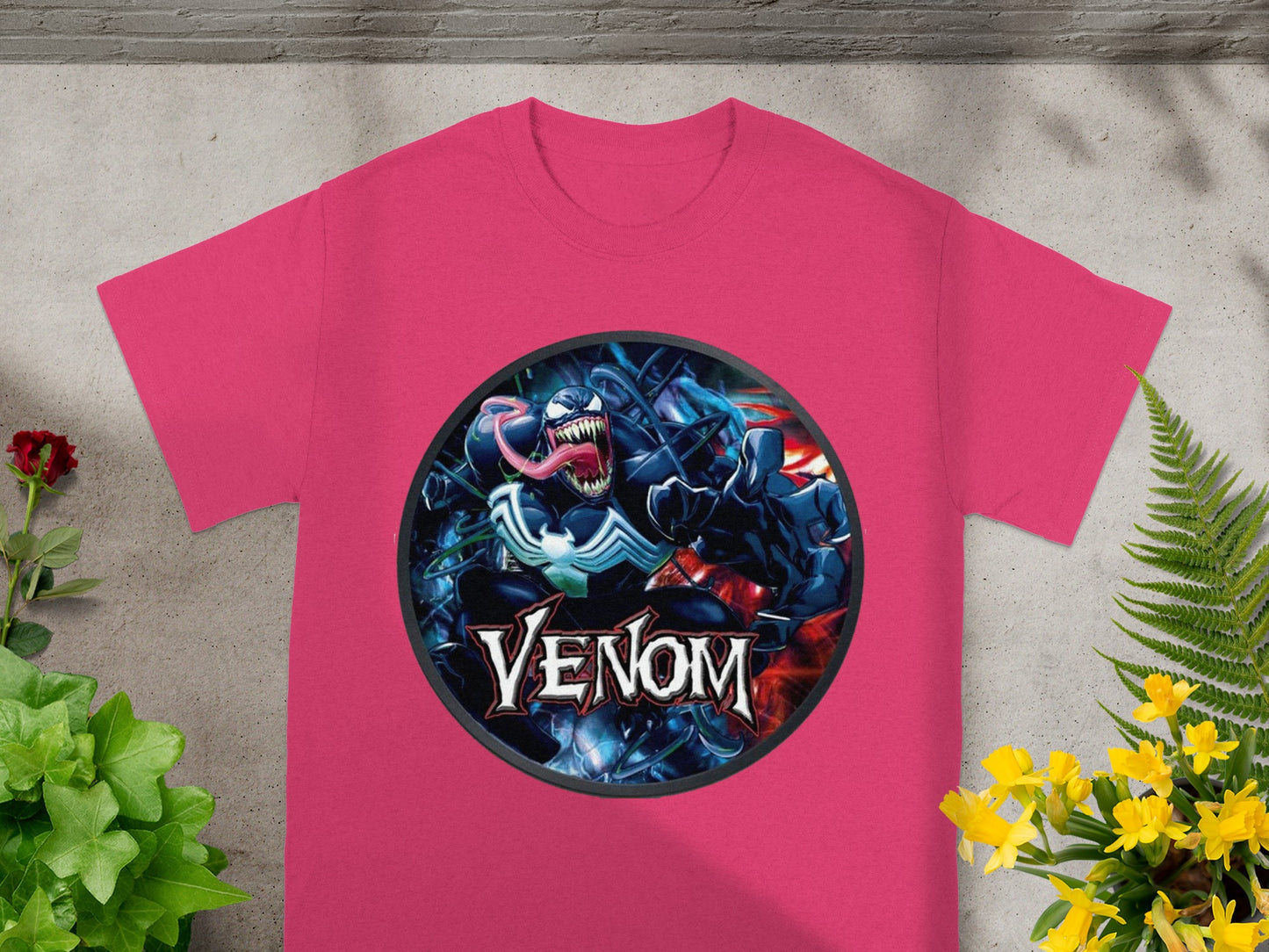Venom graphic on a pink t-shirt with foliage and flowers.