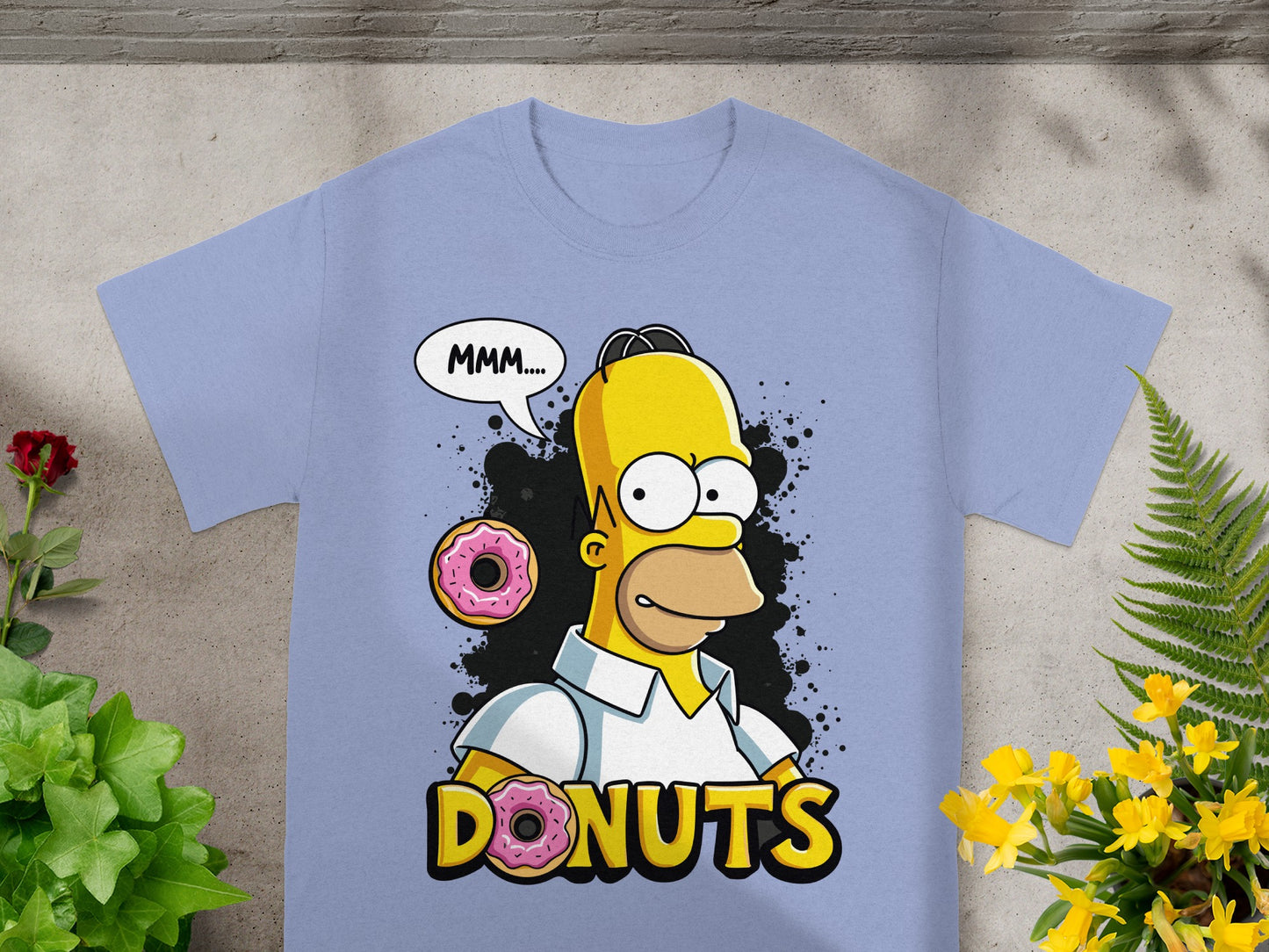 Homer Simpson saying "MMM..." with donuts on a light blue t-shirt.