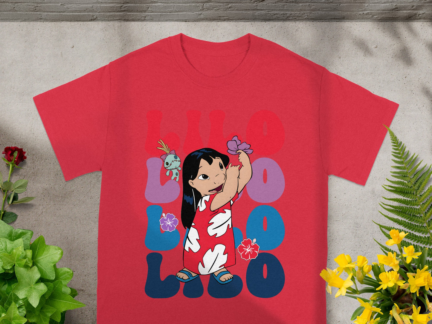 Red t-shirt with Lilo and Stitch characters and floral design.
