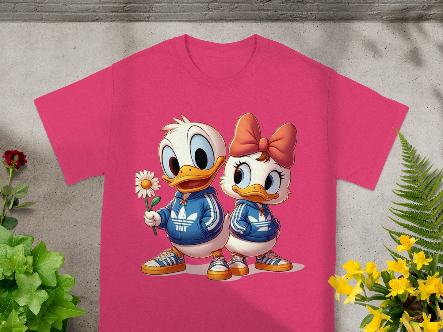Donald and Daisy Duck in matching blue tracksuits, pink t-shirt mockup.
