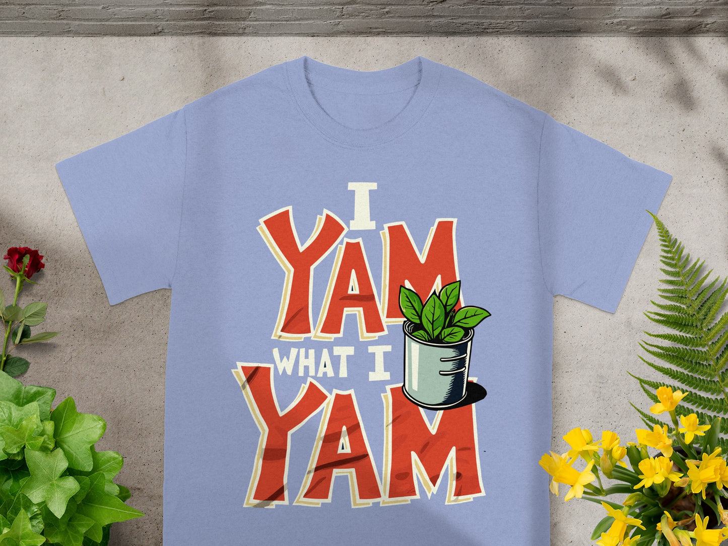 Light blue t-shirt with "I Yam What I Yam" text and potted plant graphic.