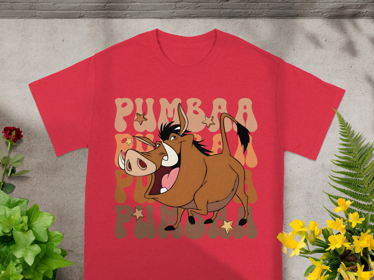 Red t-shirt with Pumbaa from The Lion King graphic and text.