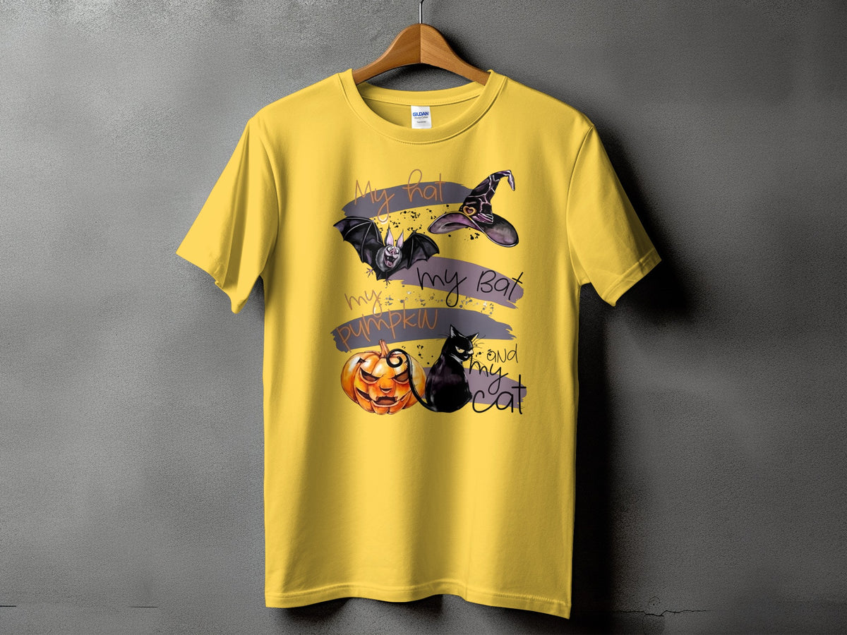 Yellow t-shirt with Halloween graphic: bat, witch hat, pumpkin, and cat with text.