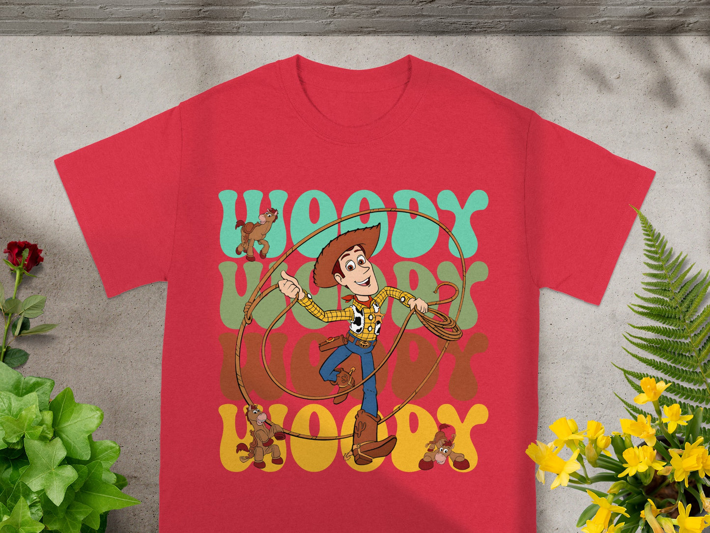 Red t-shirt featuring Woody from Toy Story and word art.
