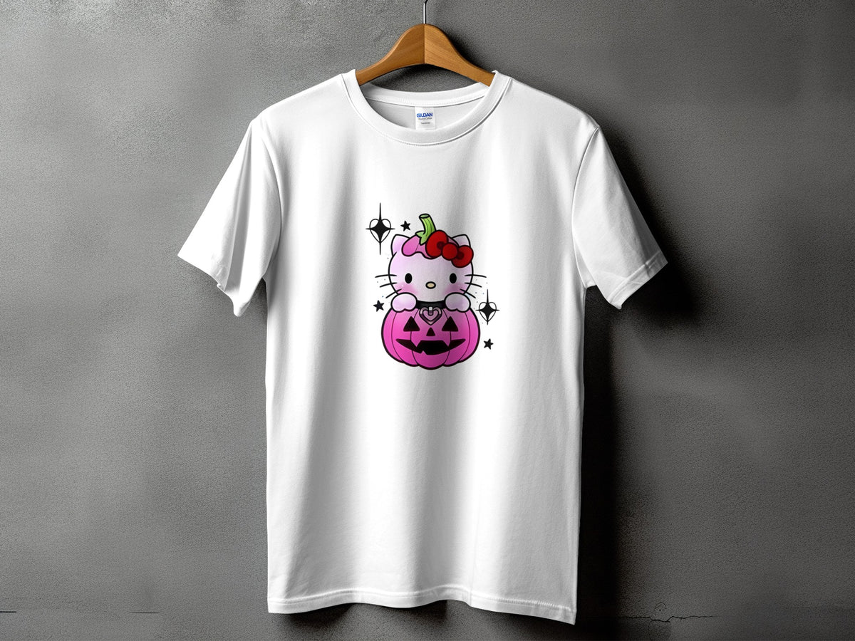 White t-shirt with pink Hello Kitty sitting on a Halloween pumpkin.