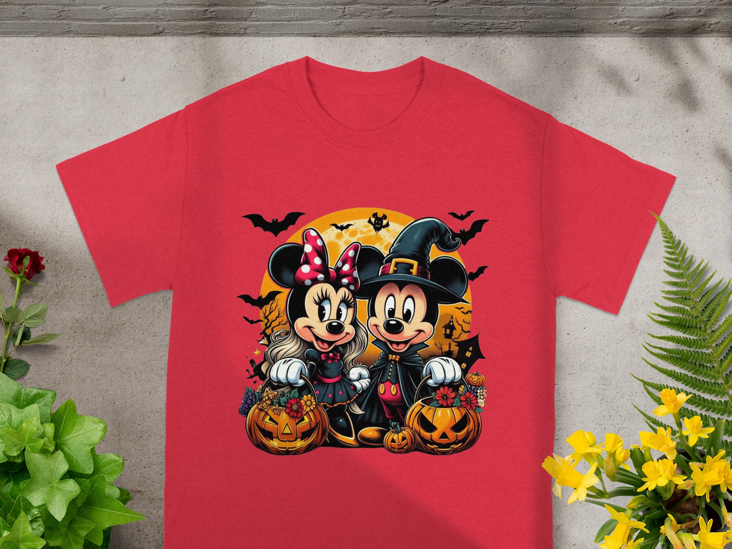 Minnie and Mickey Mouse in Halloween costumes with pumpkins and bats.