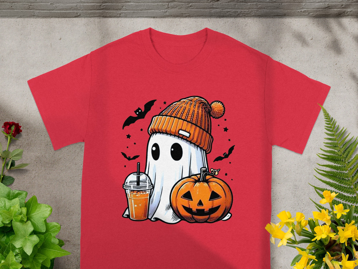 Red t-shirt with a cartoon ghost, pumpkin, drink, and bats for Halloween.