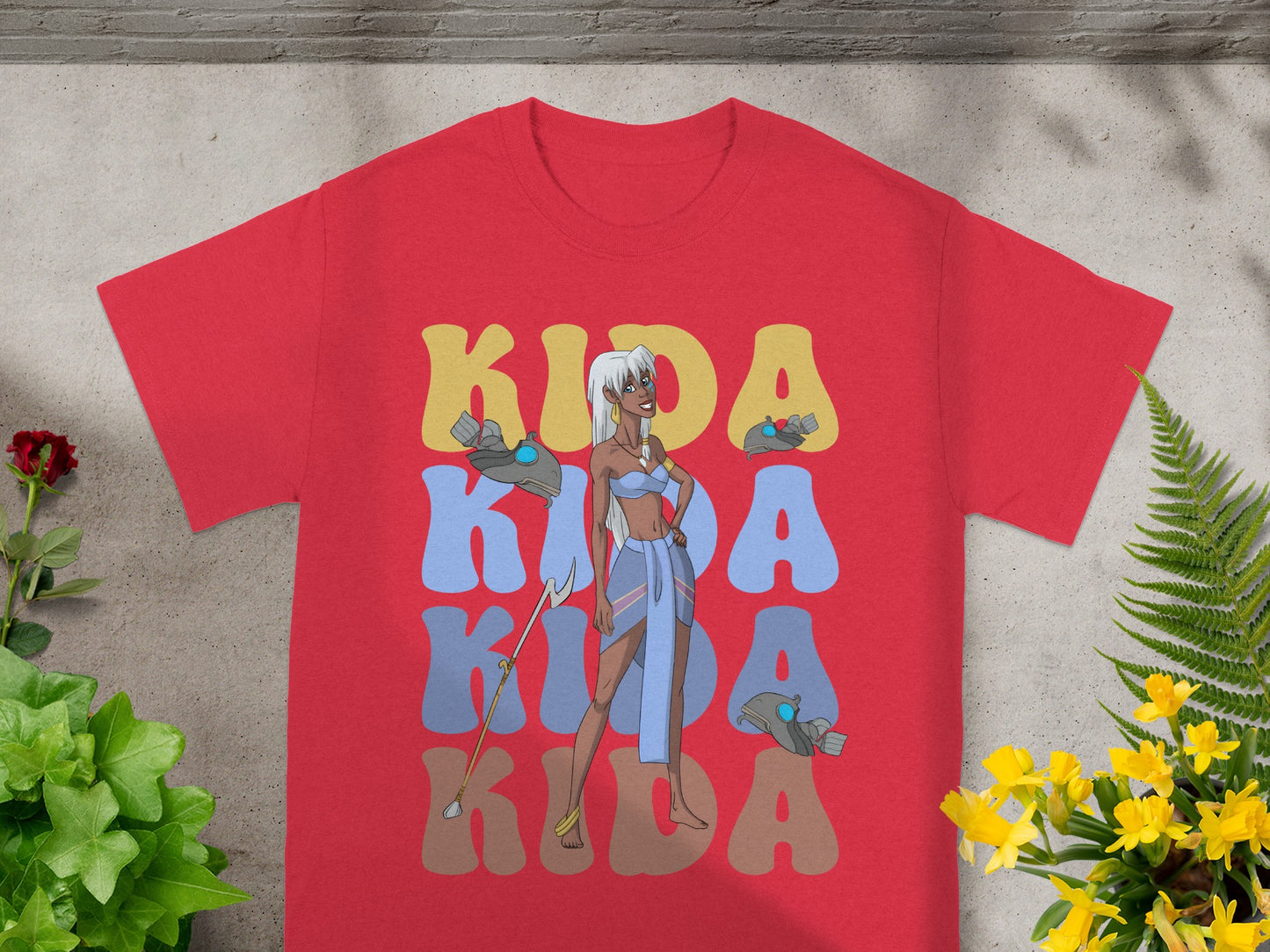 Red t-shirt with "Kida" in large stylized letters, featuring a character illustration.