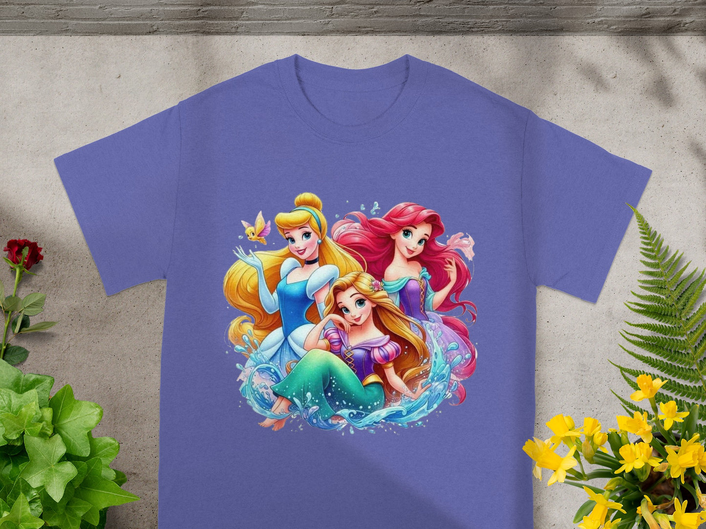 Disney Princesses Ariel, Cinderella, and Rapunzel on a purple t-shirt.