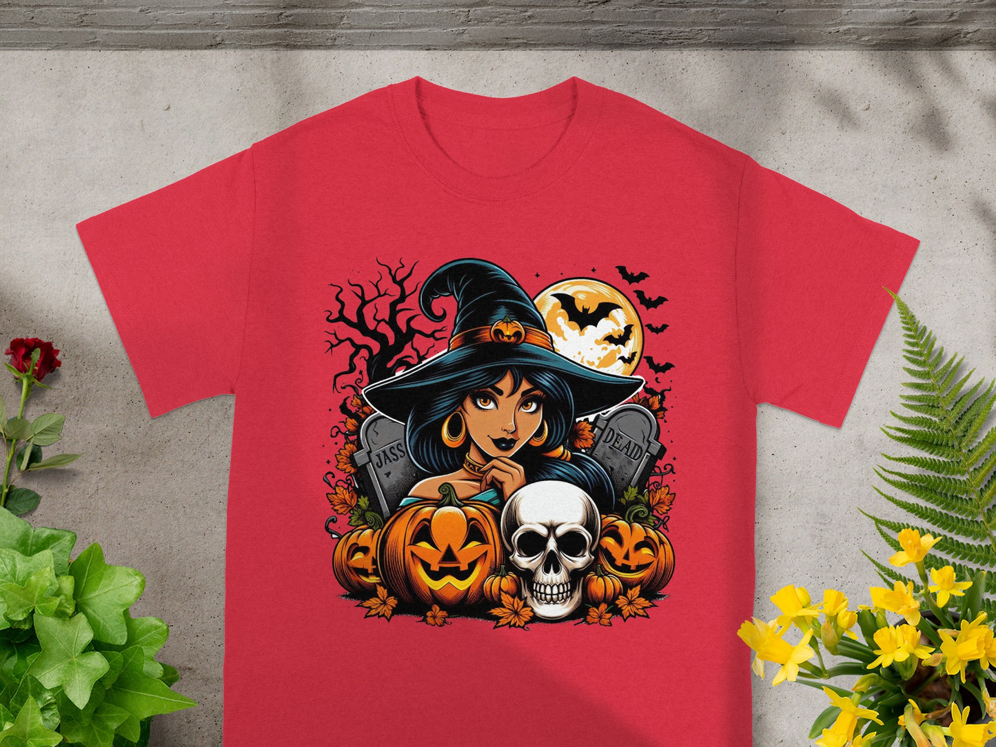 Red t-shirt with a Halloween design featuring a witch, pumpkins, skull, and tombstones.