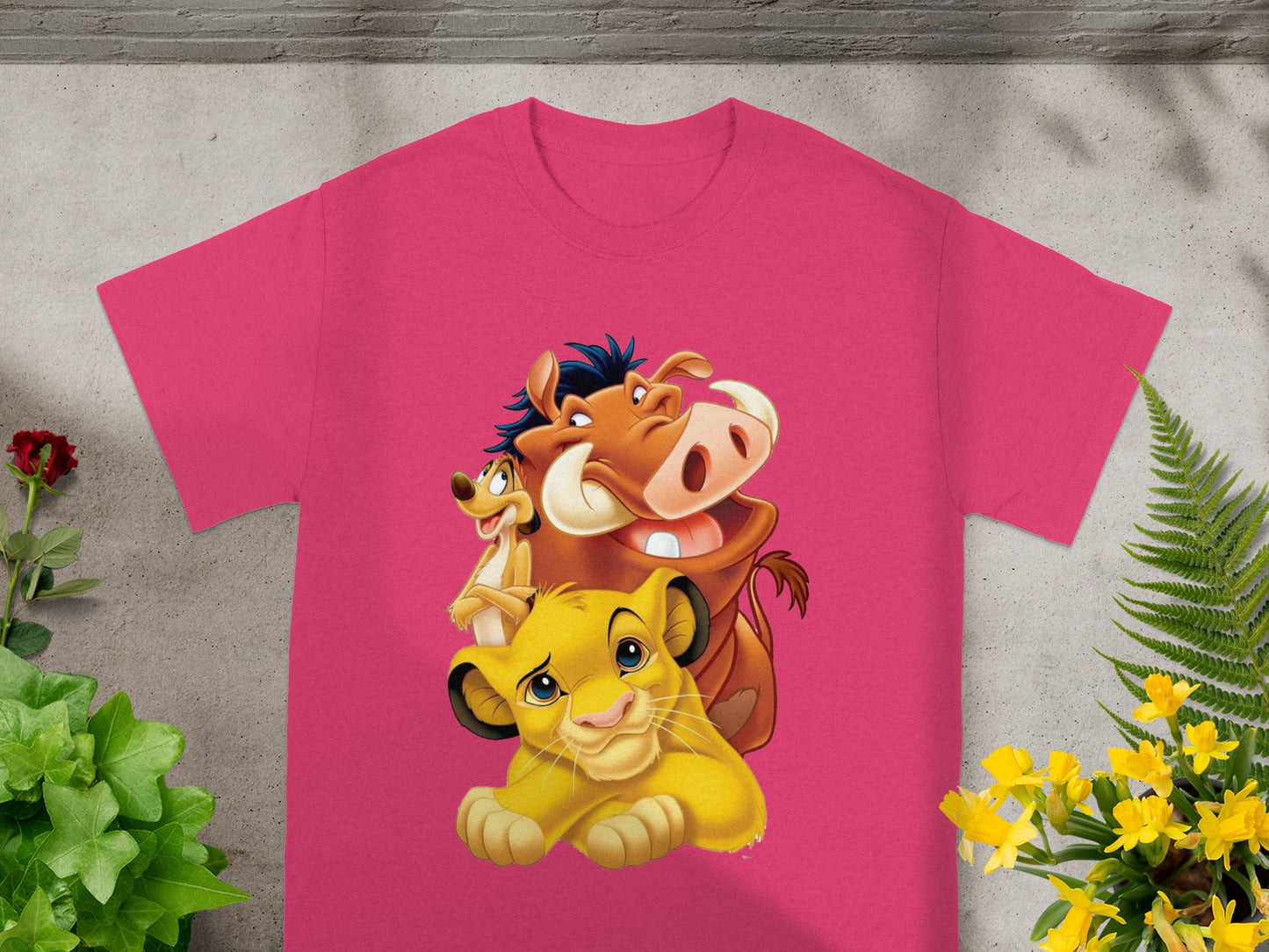 Simba, Pumbaa, and Timon from The Lion King on a pink t-shirt.