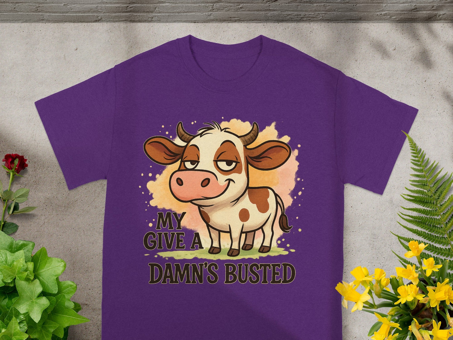 Purple t-shirt with cartoon cow and text "MY DAMN'S BUSTED".