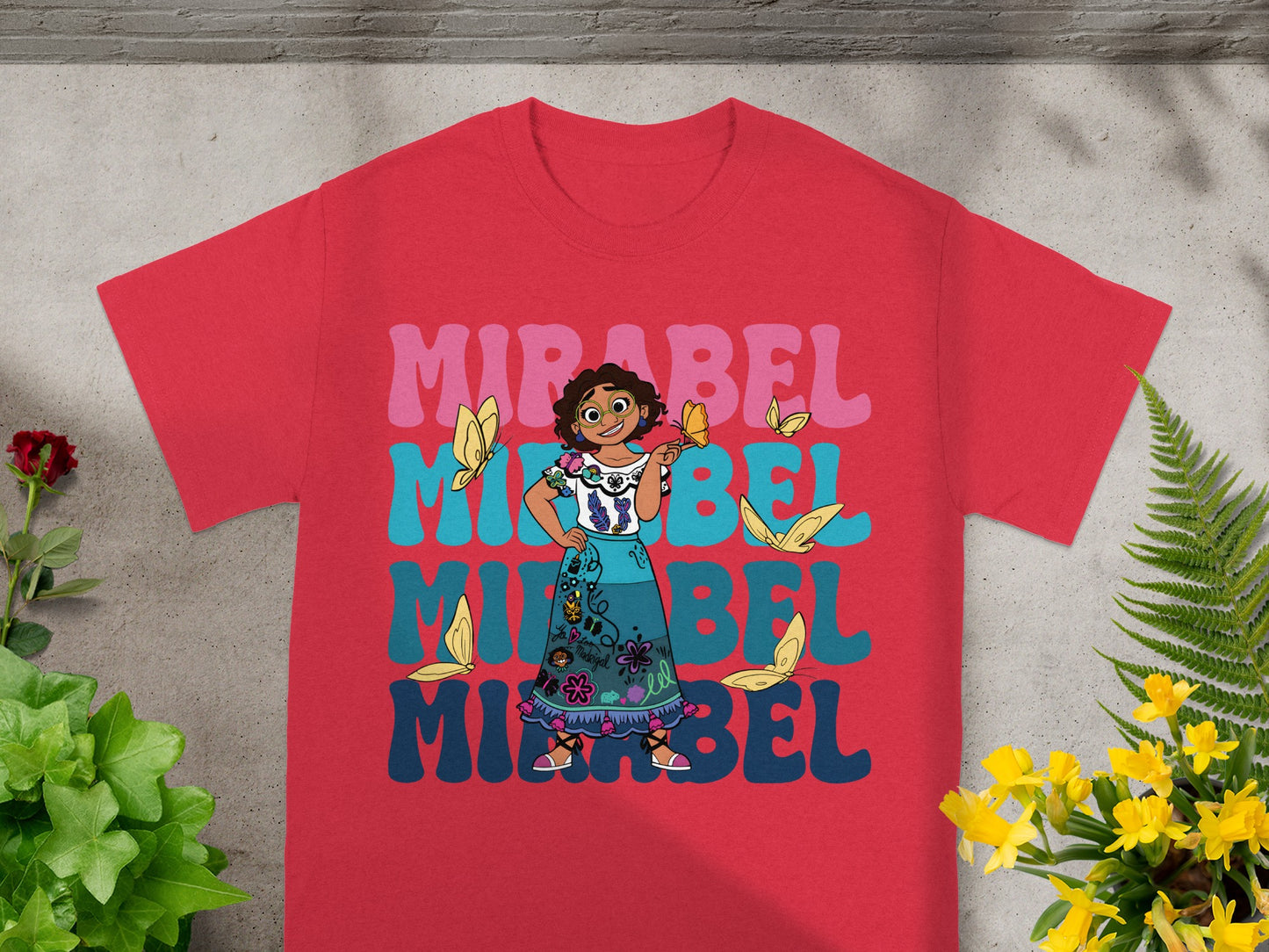 Red t-shirt with Mirabel from Encanto graphic and text.