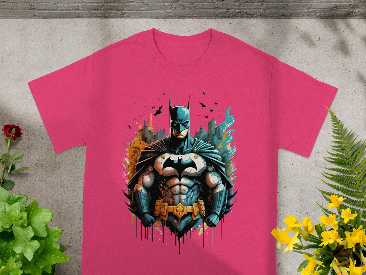 Pink t-shirt with graphic of Batman in a city skyline.