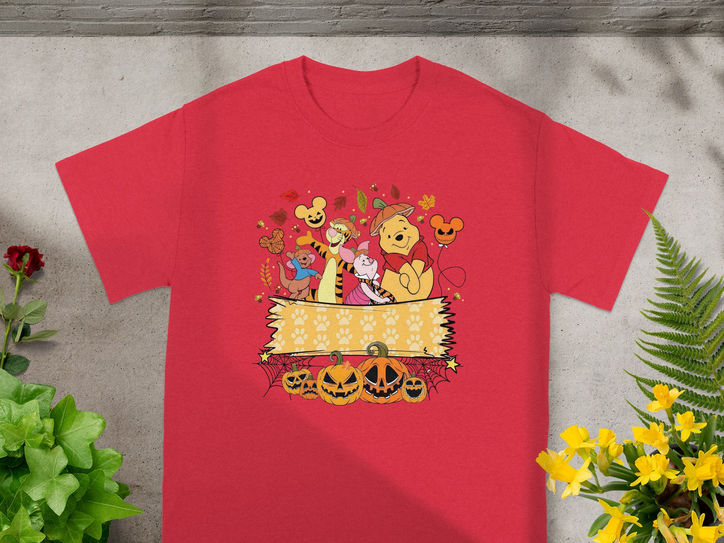 Winnie the Pooh and friends celebrate Halloween with pumpkins and paw prints.