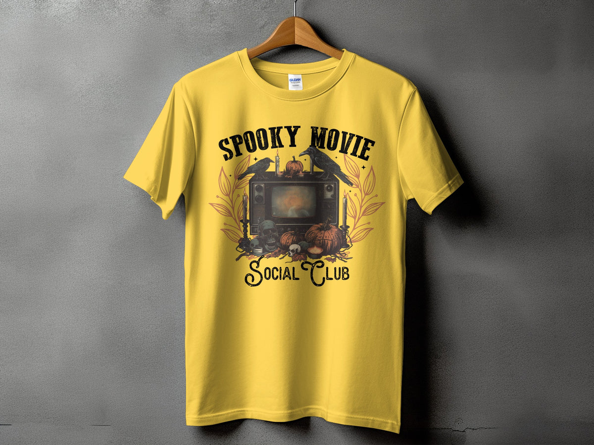 Yellow t-shirt with "Spooky Movie Social Club" text and Halloween-themed graphic.