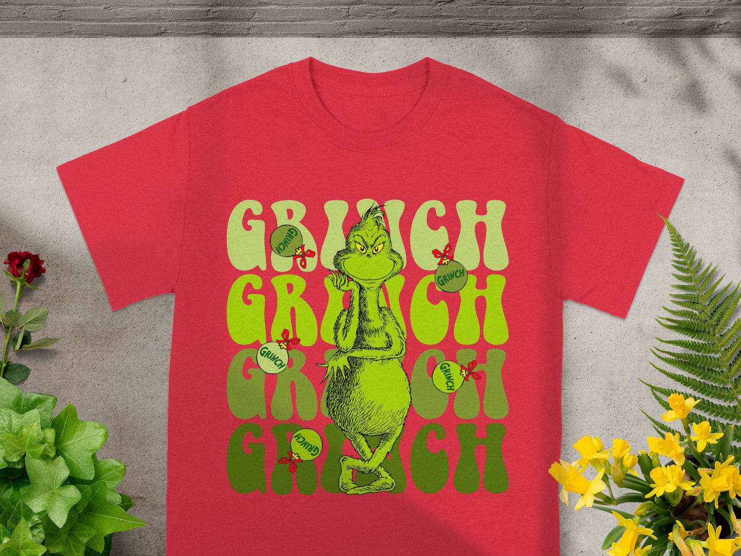 Red t-shirt with "Grinch" text and Grinch illustration.