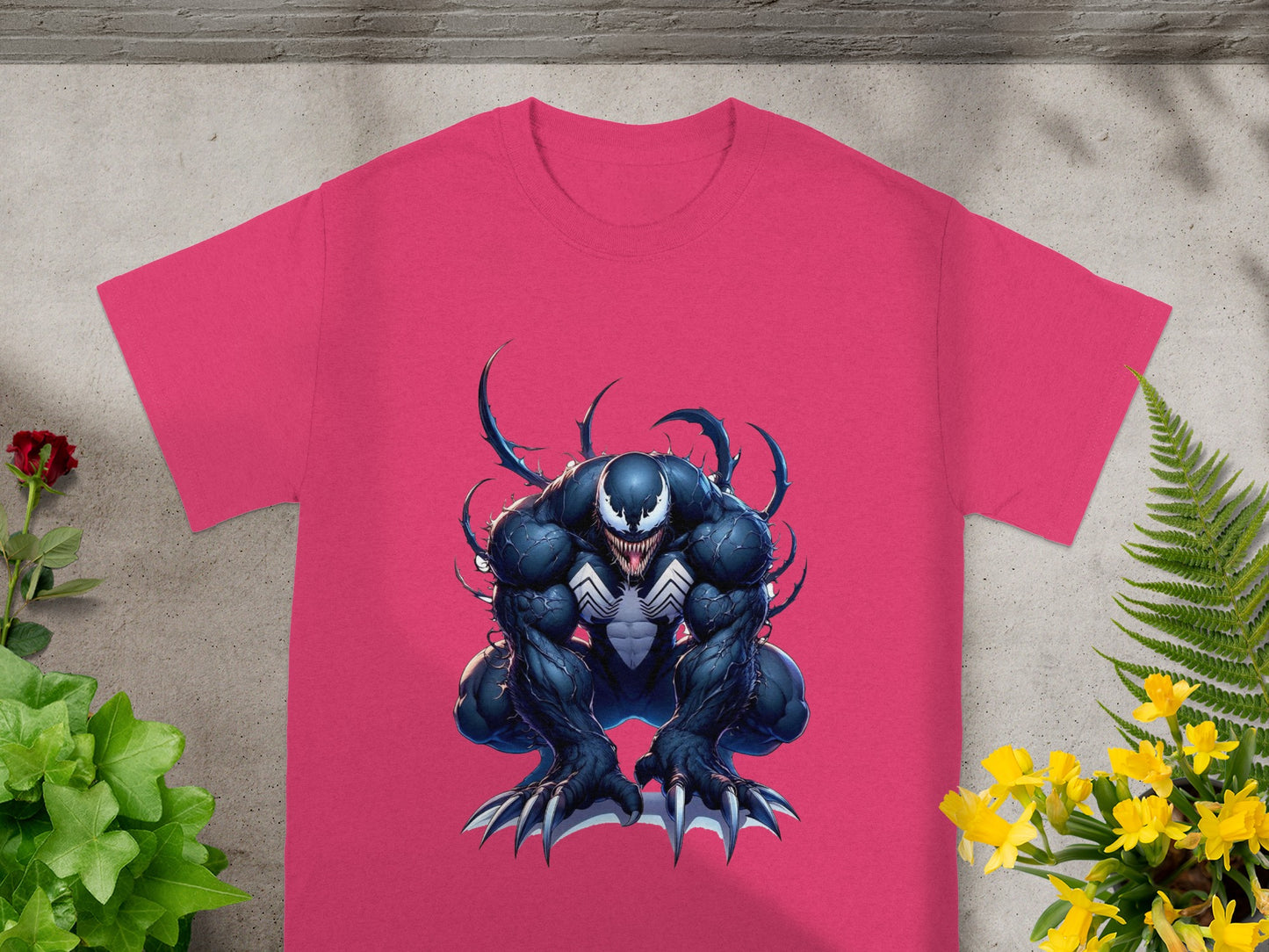 Pink t-shirt with Venom graphic art and white text.