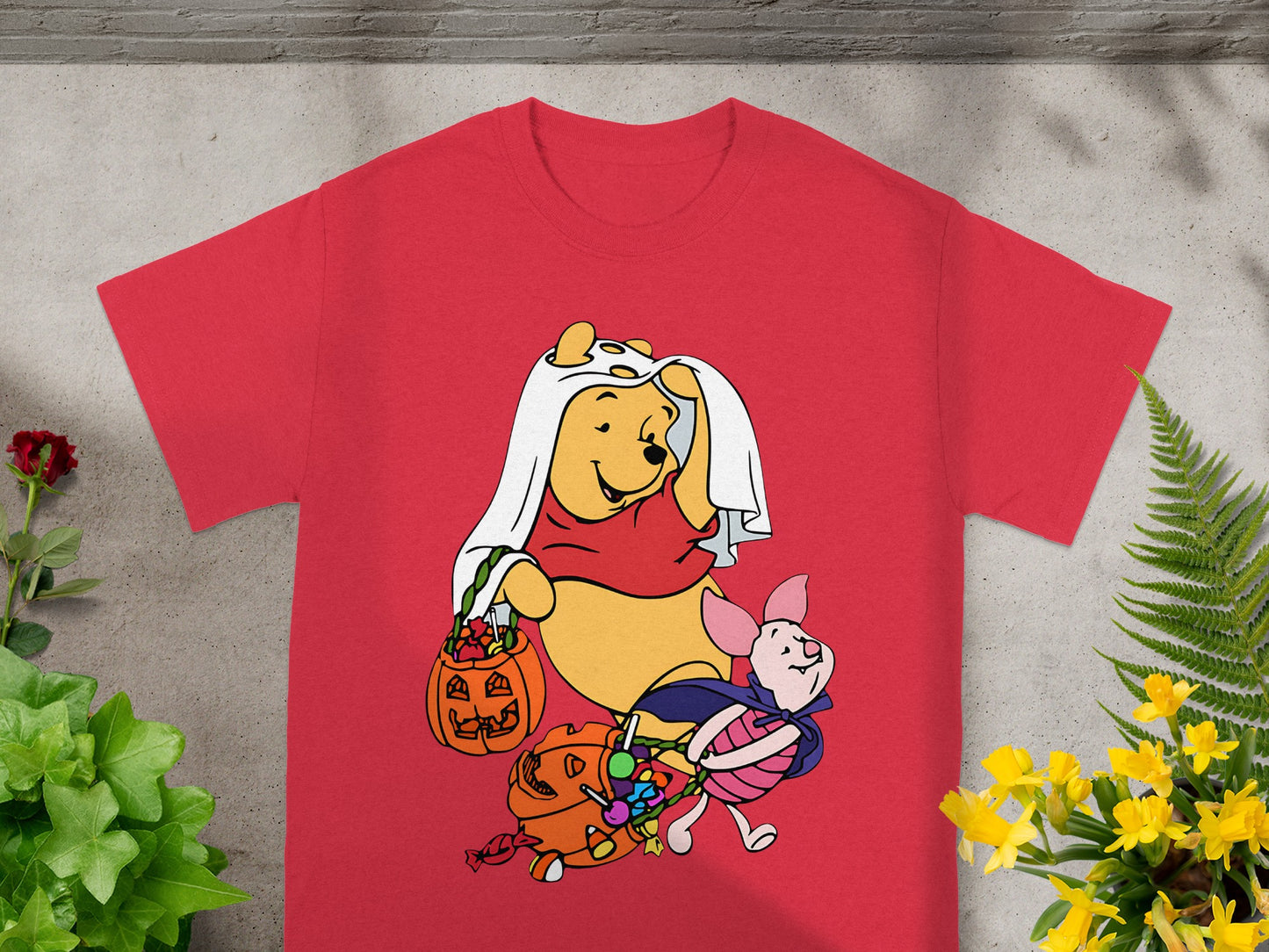 Winnie the Pooh and Piglet in Halloween costumes with candy.