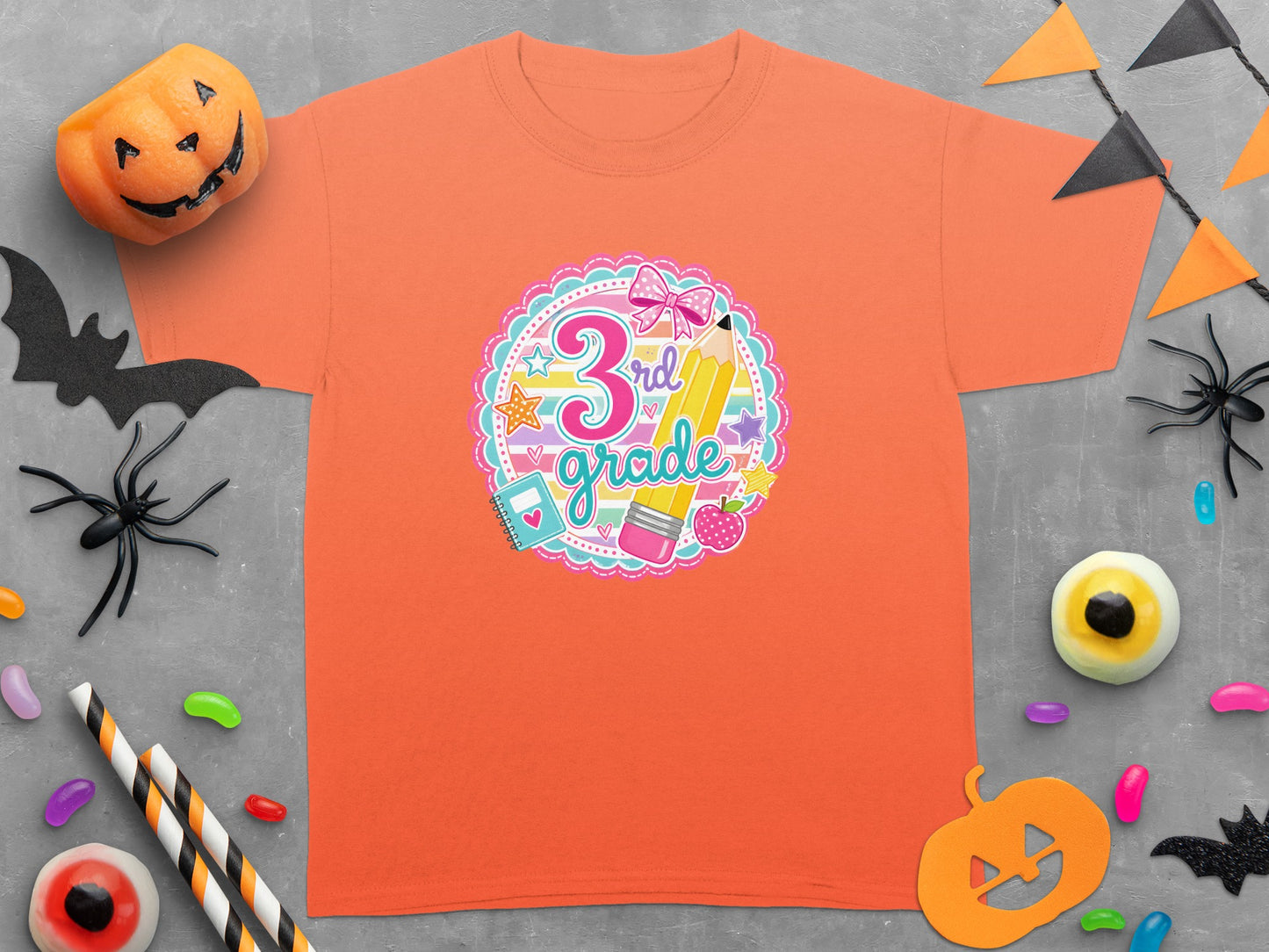 Orange t-shirt with "3rd grade" graphic featuring a pencil and bow.