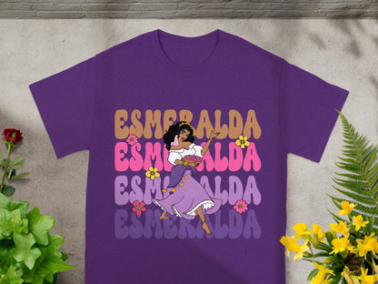 Esmeralda dancing in a purple shirt with colorful text.