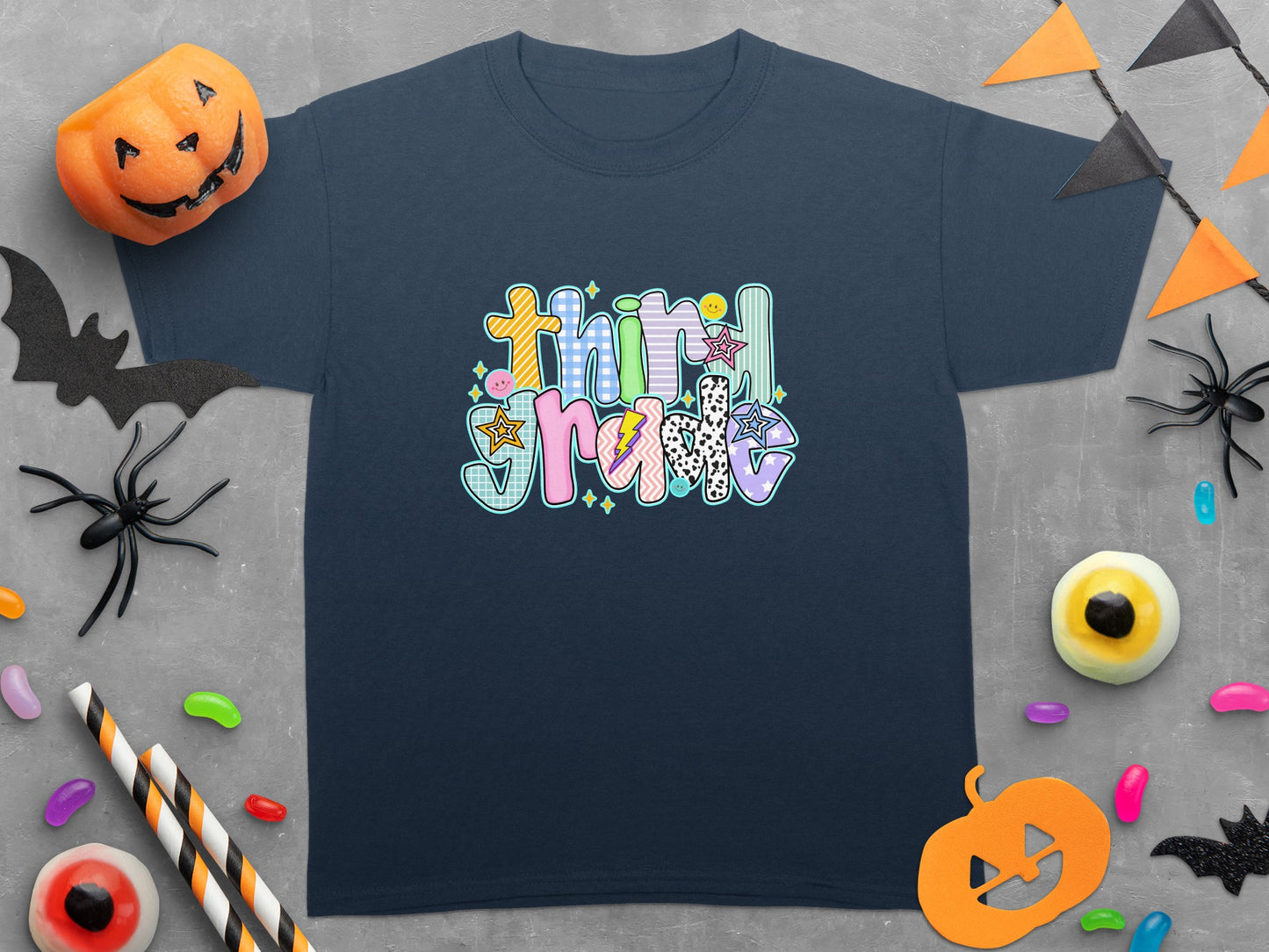 Dark blue t-shirt with "Third Grade" text in colorful, patterned letters.