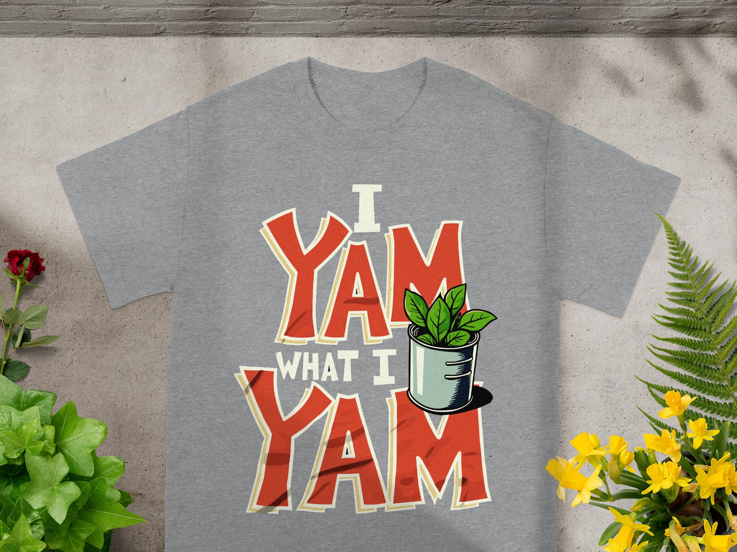 Grey t-shirt with "I YAM WHAT I YAM" text and a plant in a pot.