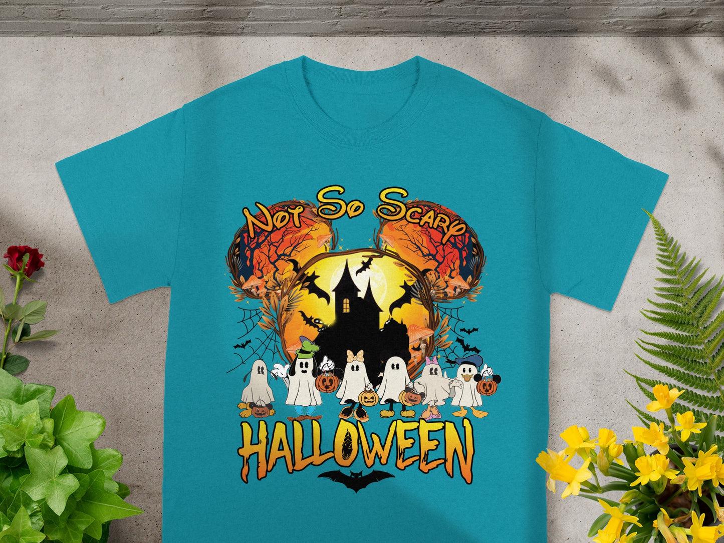 Teal t-shirt with "Not So Scary Halloween" design featuring ghosts and a haunted house.