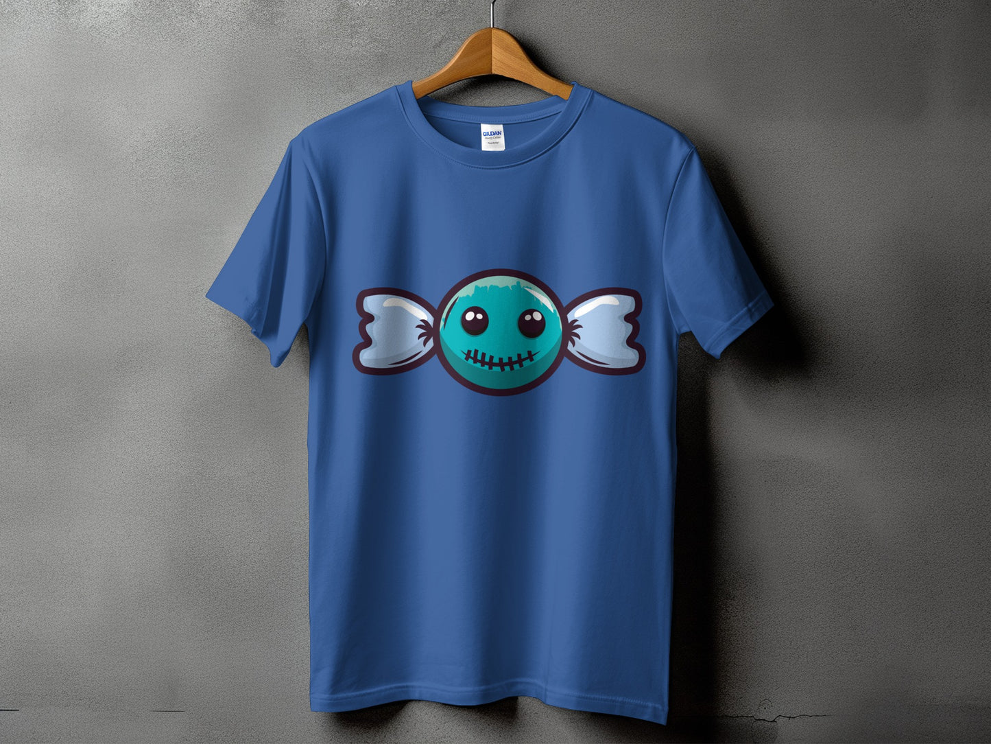 Blue t-shirt with a cartoon candy graphic featuring a stitched mouth and eyes.