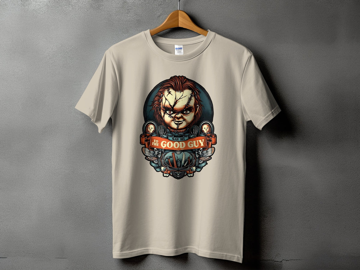 Chucky doll graphic on a tan t-shirt with "Say Hi To The Good Guy" text.
