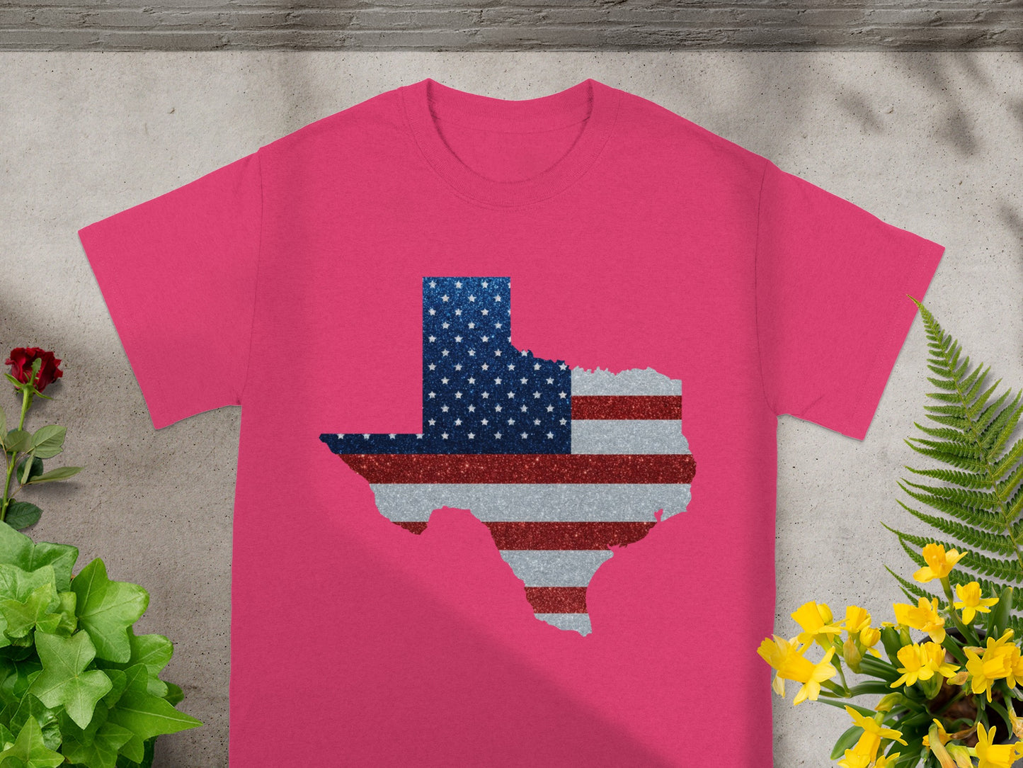 Pink t-shirt with a Texas outline filled with American flag glitter design.