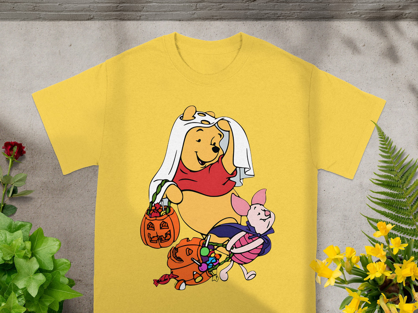 Winnie the Pooh and Piglet in Halloween costumes collecting candy from pumpkins.