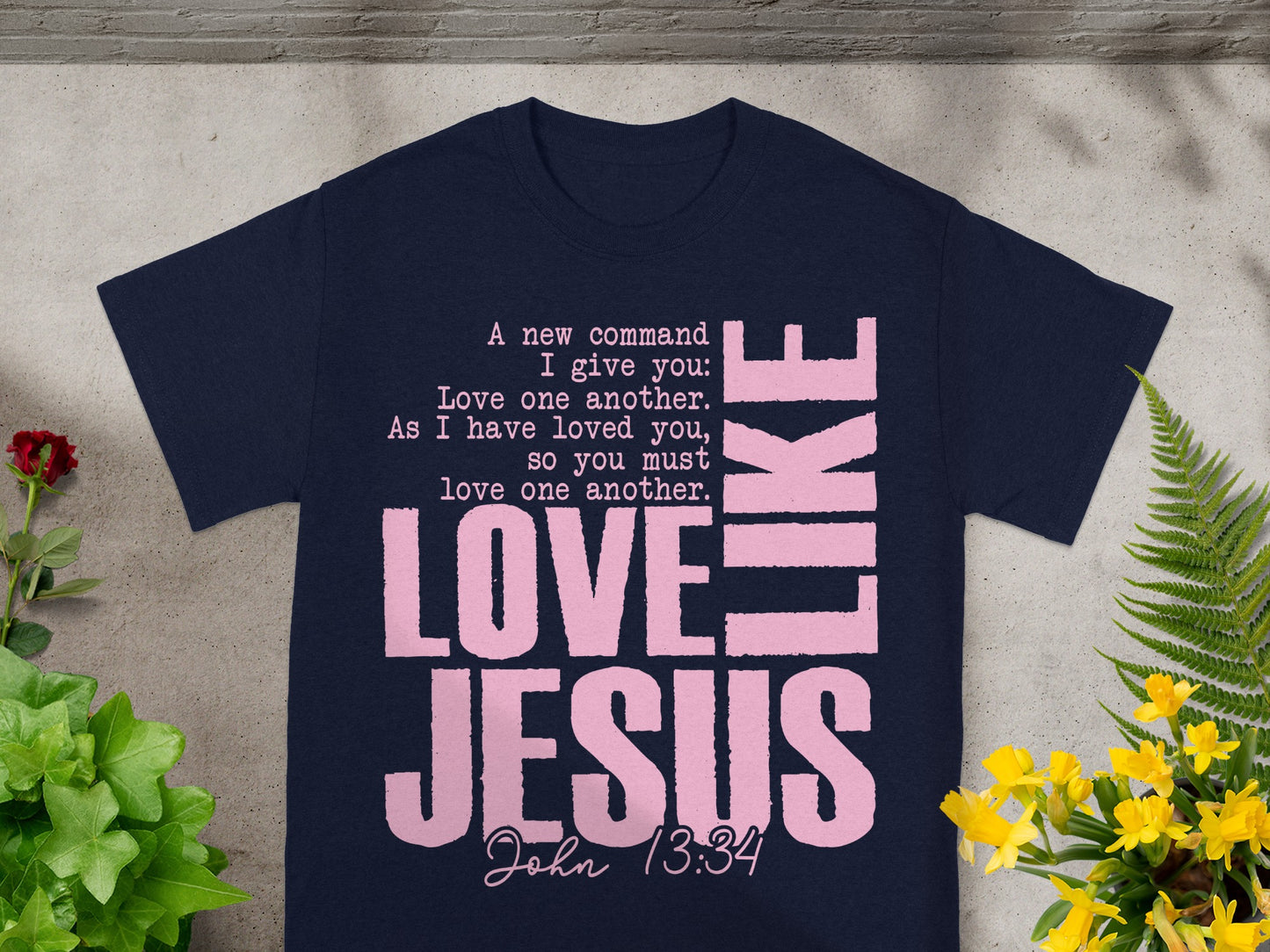Navy t-shirt with pink text "LOVE JESUS" and Bible verse John 13:34.