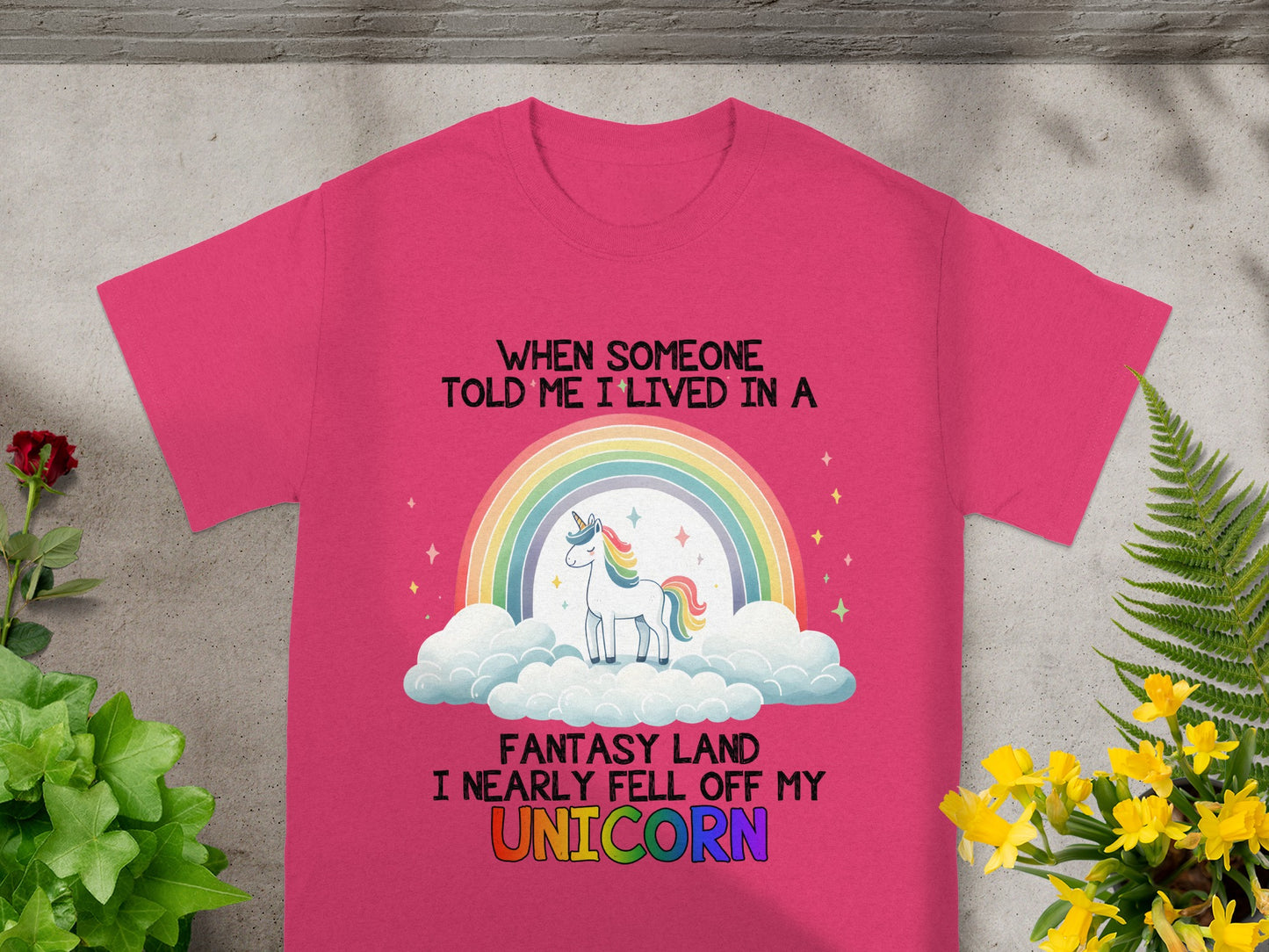 Pink t-shirt with text and unicorn graphic.