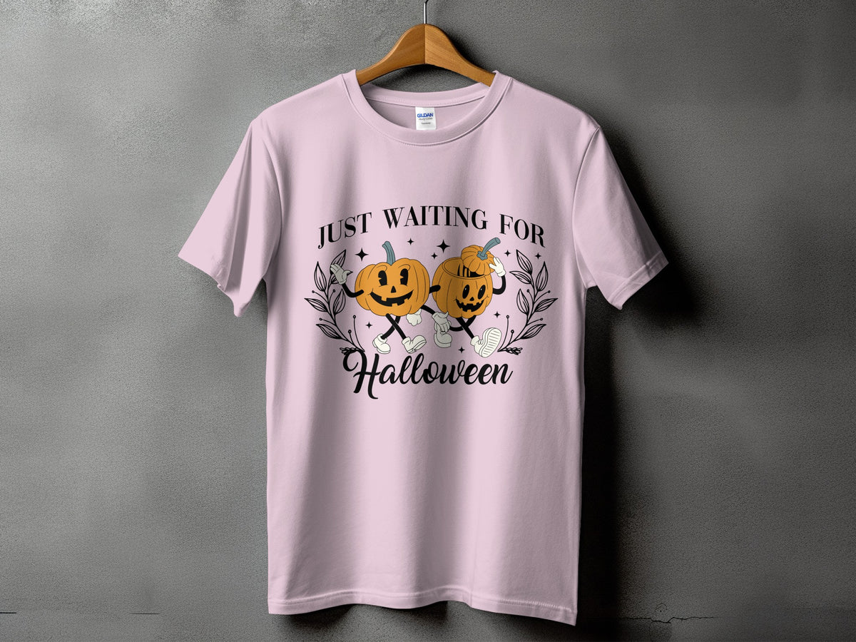 Pink t-shirt with "Just Waiting For Halloween" text and cartoon pumpkins.