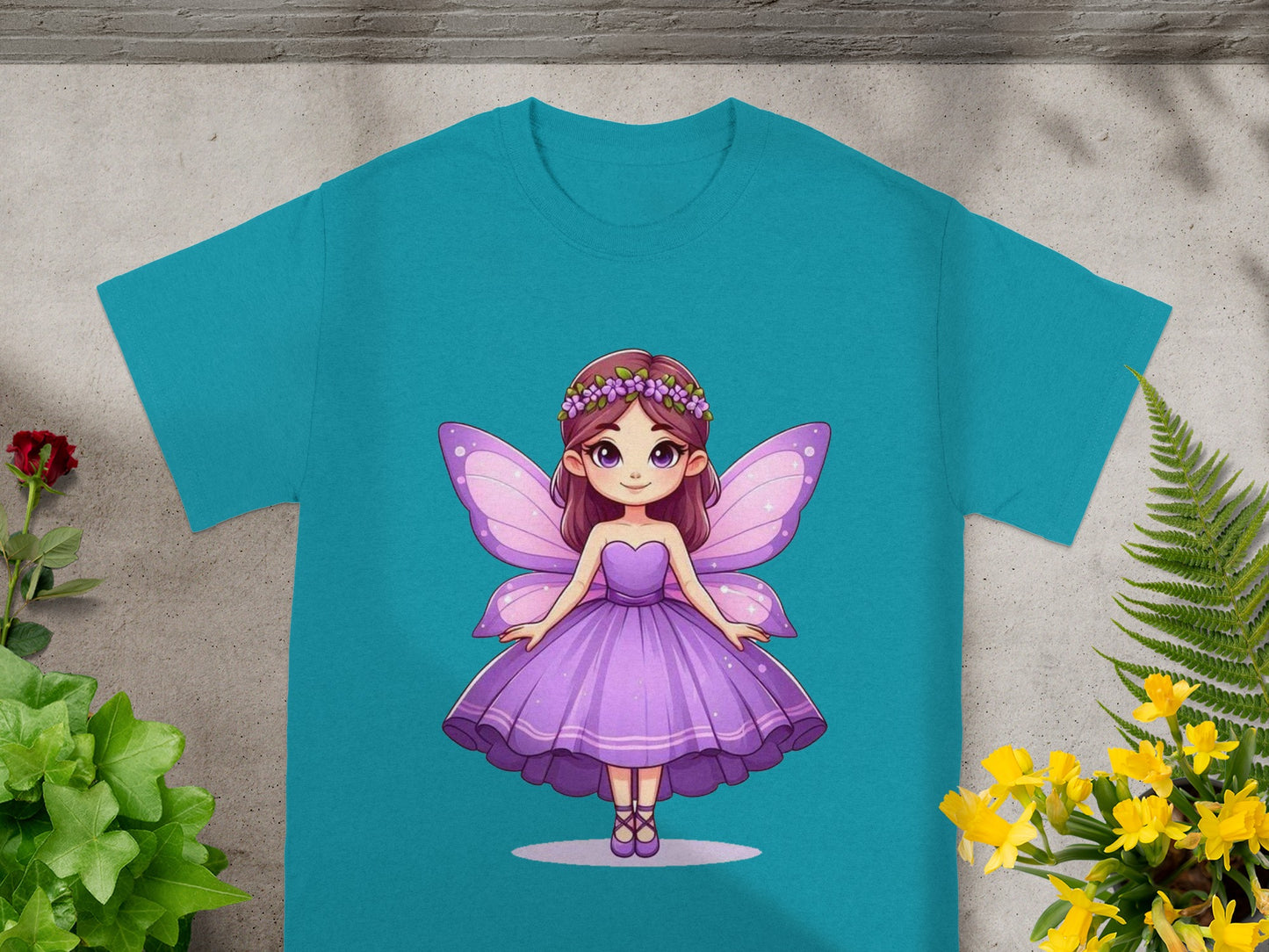 Teal t-shirt with illustration of a fairy in a purple dress.