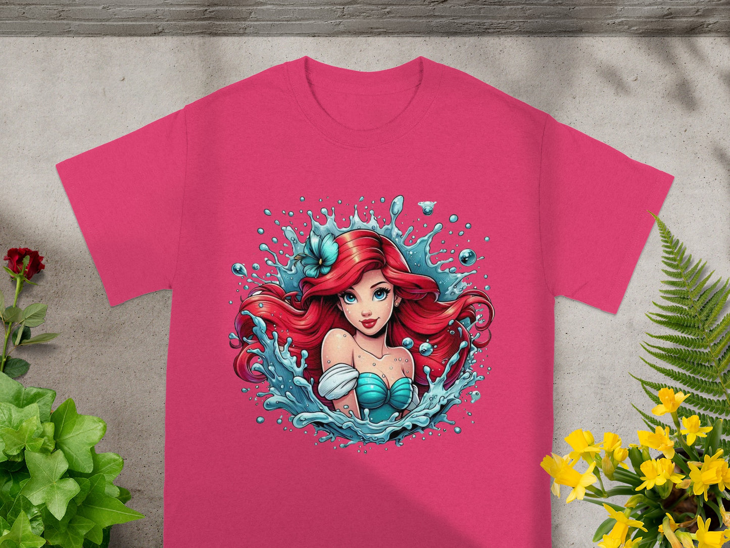 Pink t-shirt featuring Ariel from The Little Mermaid in splashing water.