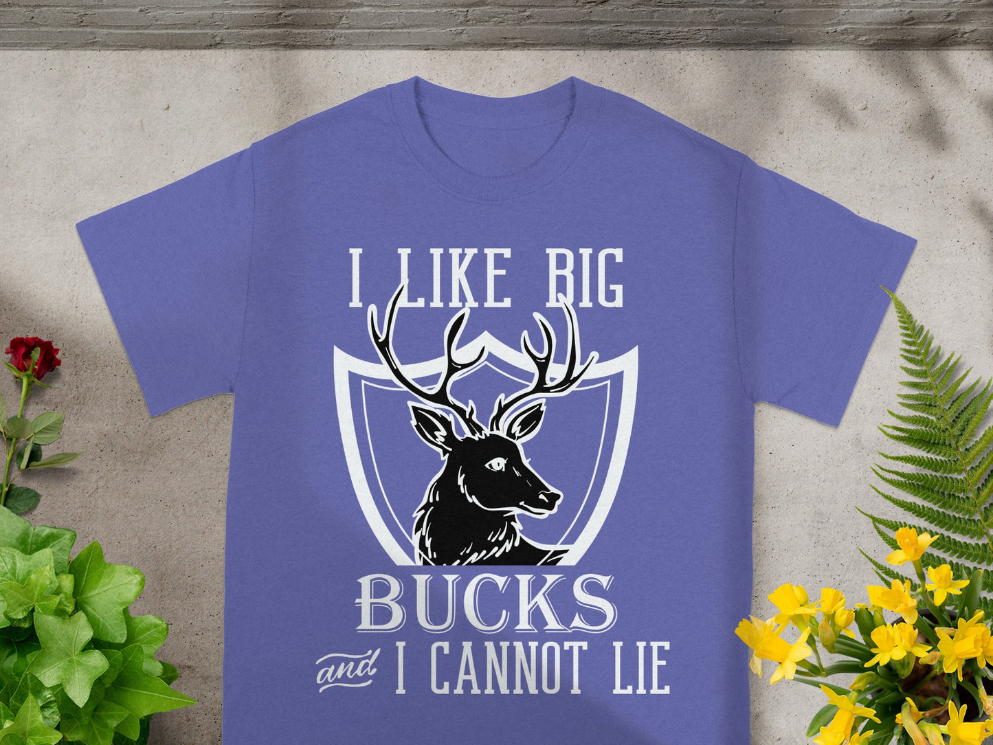 Purple t-shirt with text "I LIKE BIG BUCKS and I CANNOT LIE" and deer graphic.