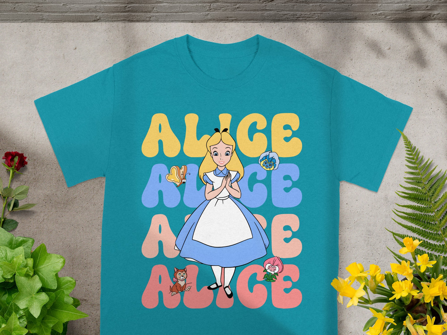 Teal t-shirt with "Alice" in large colorful letters and Alice character.