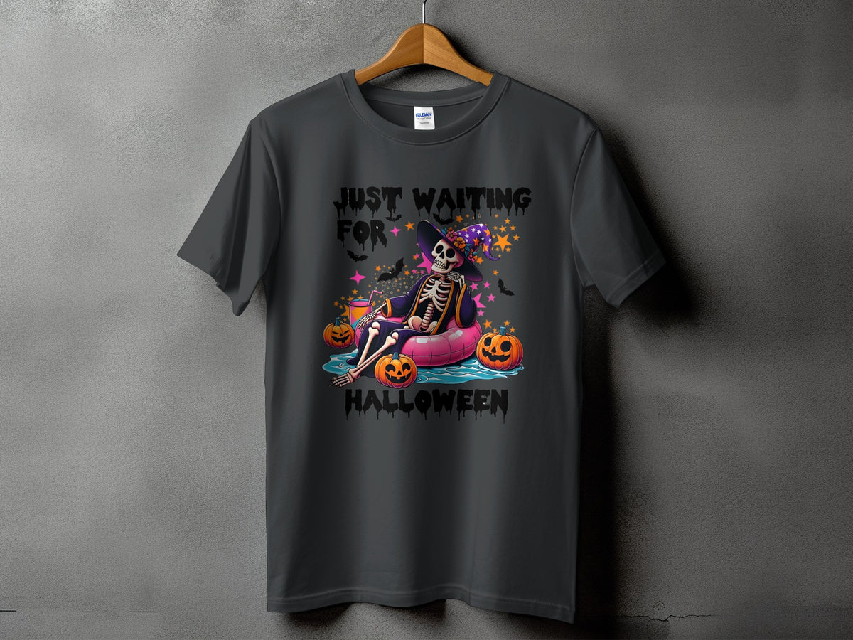 Skeleton wearing witch hat floating with pumpkins, text reads "Just Waiting For Halloween."