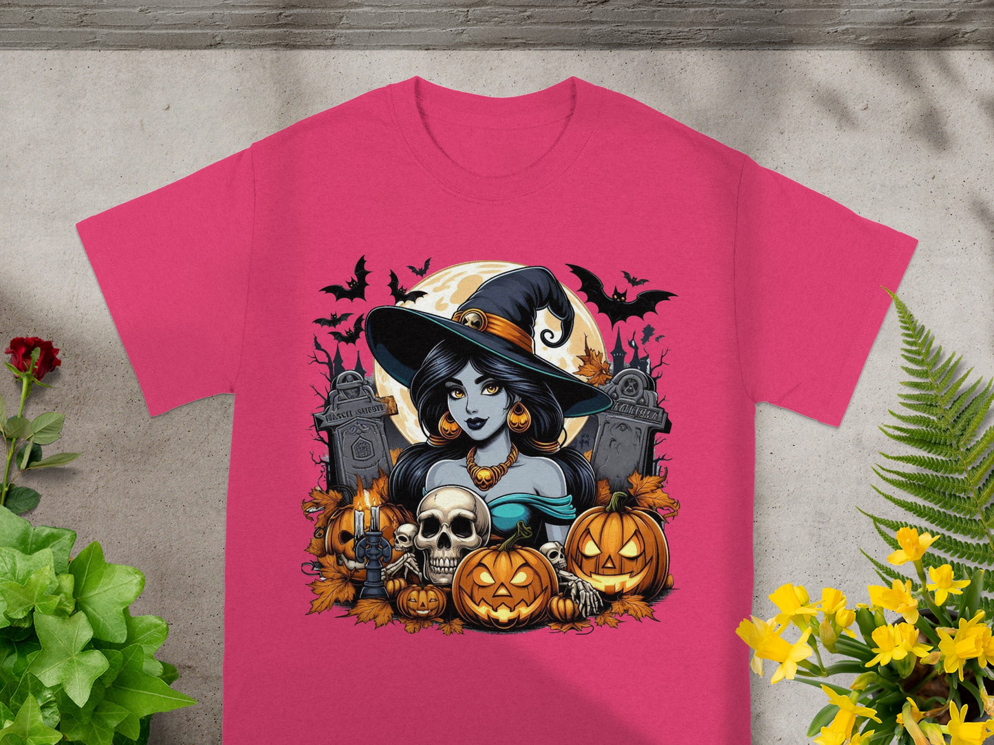 Halloween t-shirt with a witch, pumpkins, skulls, and tombstones in a graveyard.