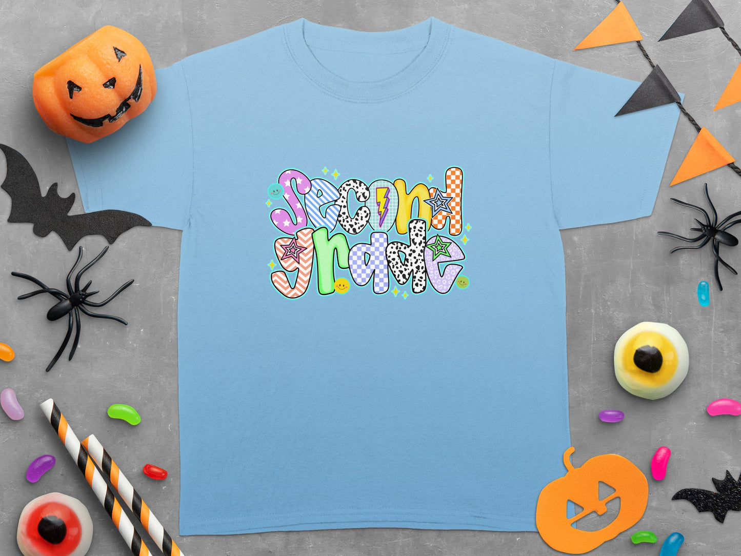Light blue t-shirt with the words "Second Grade" in colorful, patterned letters.