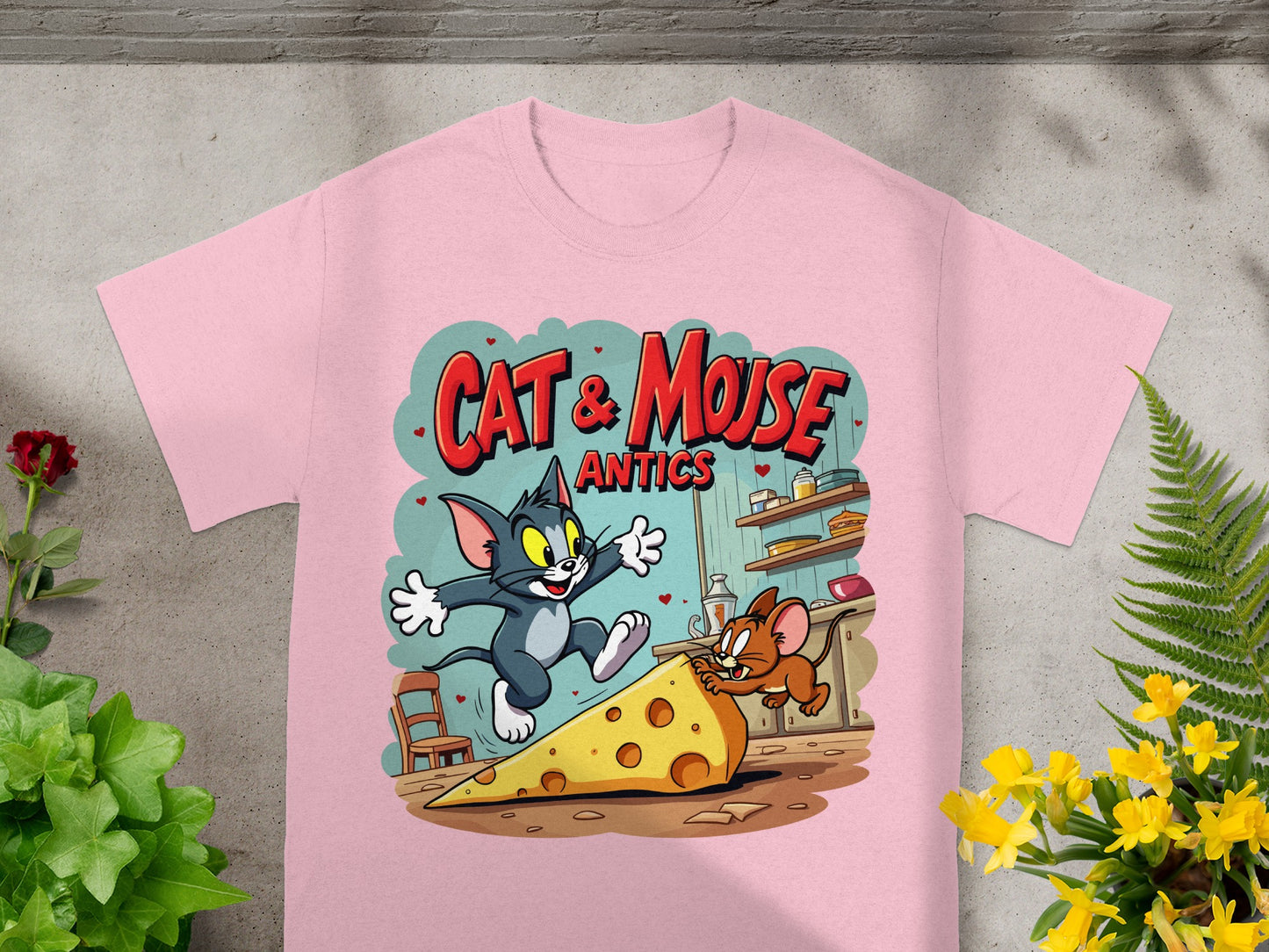 Pink t-shirt with Cat & Mouse Antics graphic featuring Tom and Jerry chasing cheese.