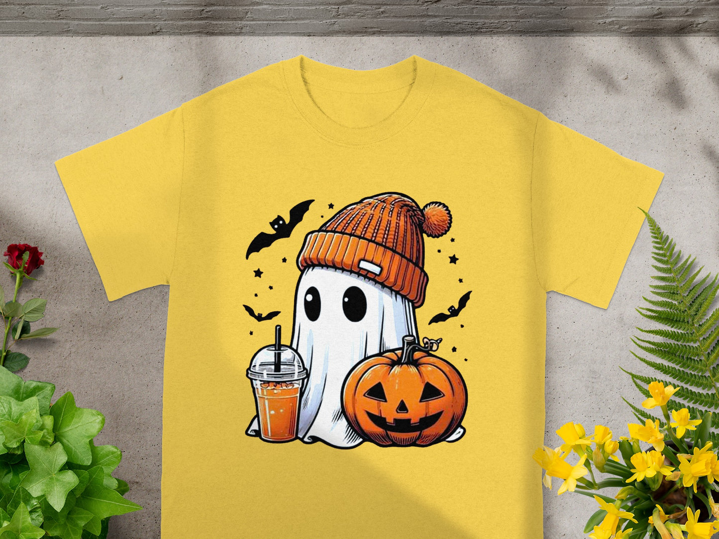 Yellow t-shirt with cartoon ghost, pumpkin, drink, and bats for Halloween.