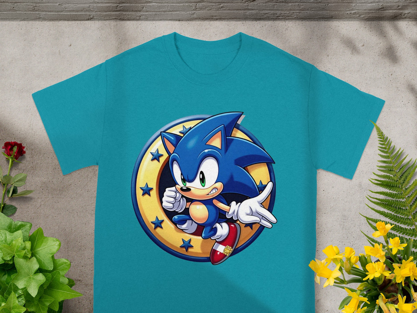 Sonic the Hedgehog in a golden circle with stars, on a teal t-shirt.