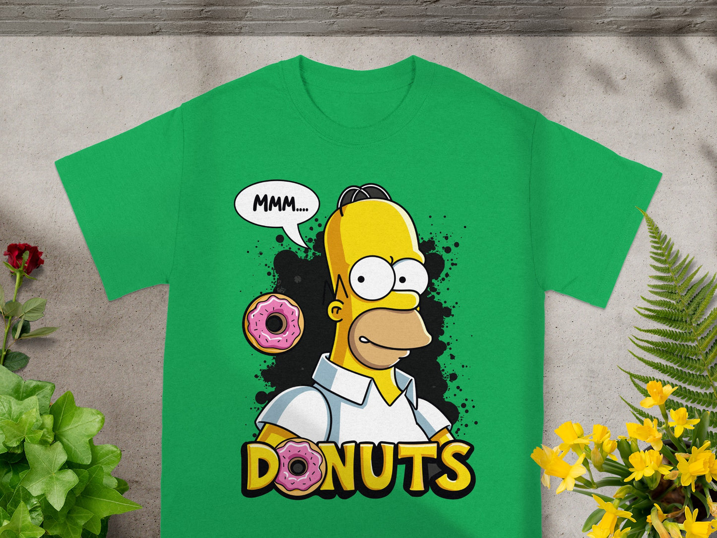 Green t-shirt with Homer Simpson saying "MMM..." next to two donuts.
