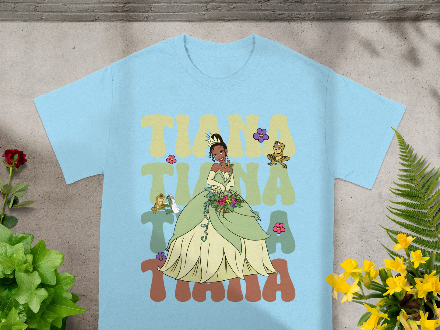 Light blue t-shirt with Tiana graphic and flowers.