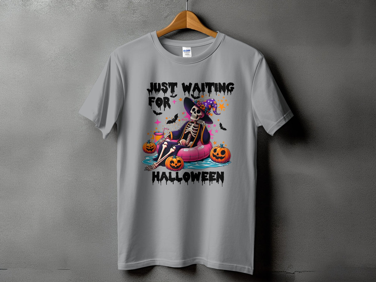 Skeleton wearing witch hat floating with pumpkins, text "JUST WAITING FOR HALLOWEEN".