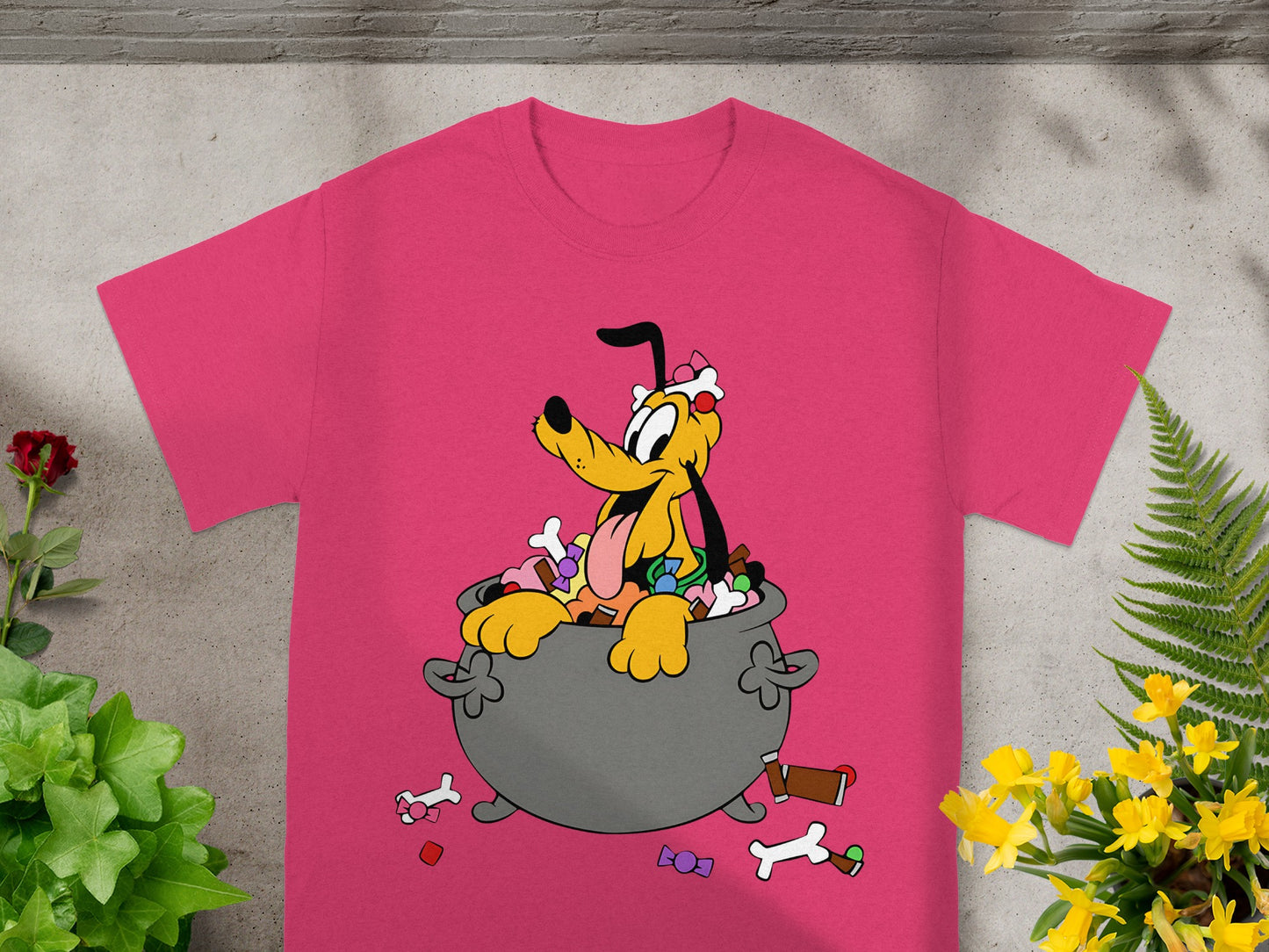 Pink t-shirt with cartoon Pluto sitting in a cauldron of candy and treats.